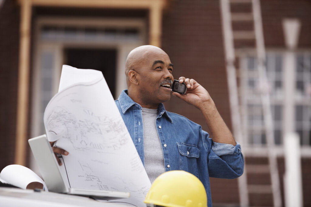 Male contractor on the phone