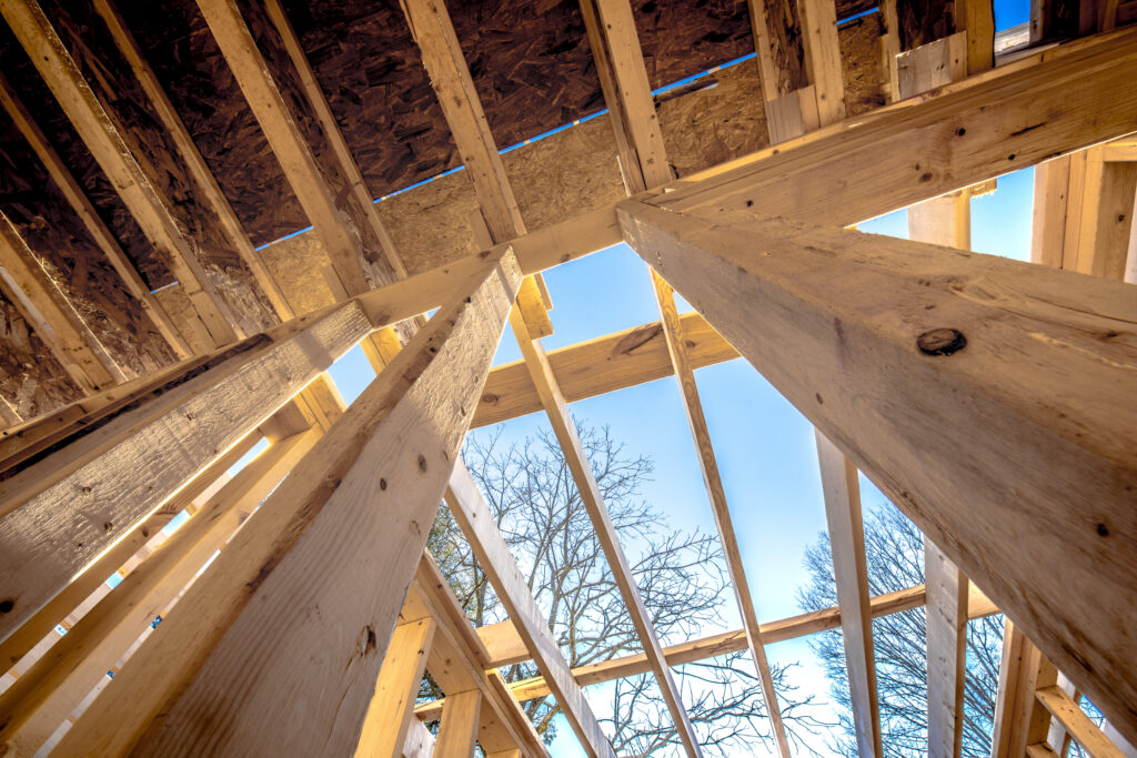 Wood building frame structure on new development site, with Sky
