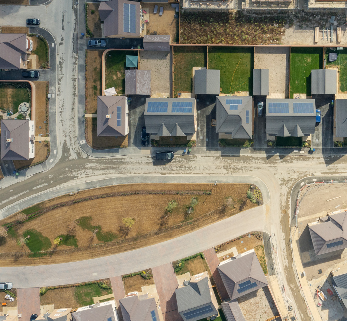 Drone view of houses. The houses are being built with solar panels on the roof - sustainable living
